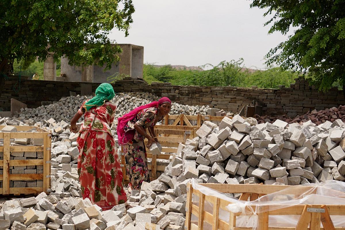 Women stacking cobbles 