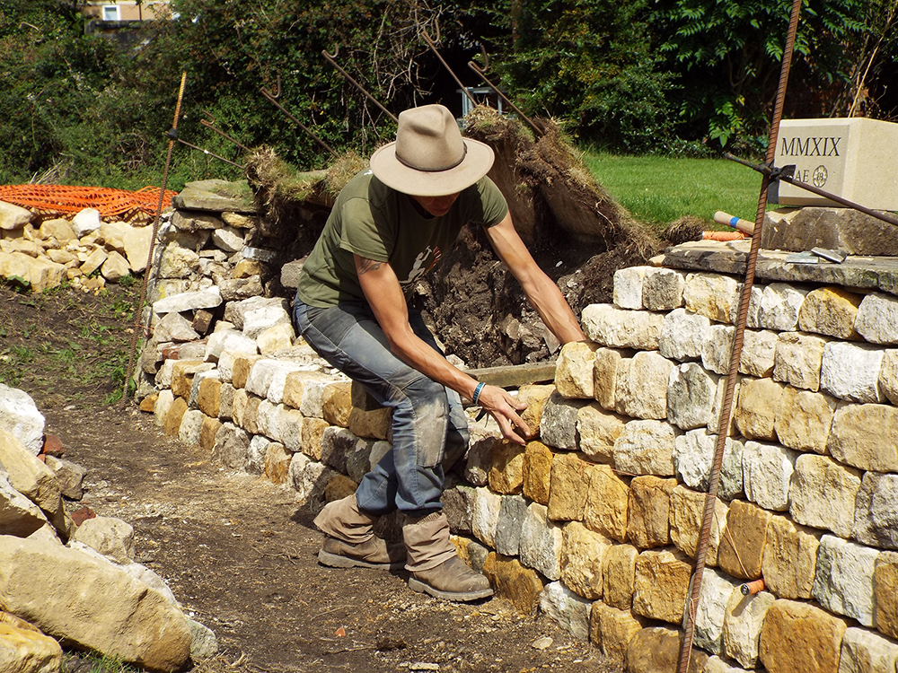 Emma Knowles building a dry stone wall Emma Knowles building a dry stone wall