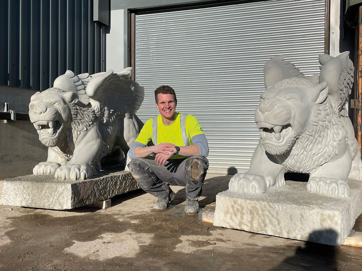Ryan outside his workshop at Traditional Stone with the two completed griffins Ryan outside his workshop at Traditional Stone with the two completed griffins