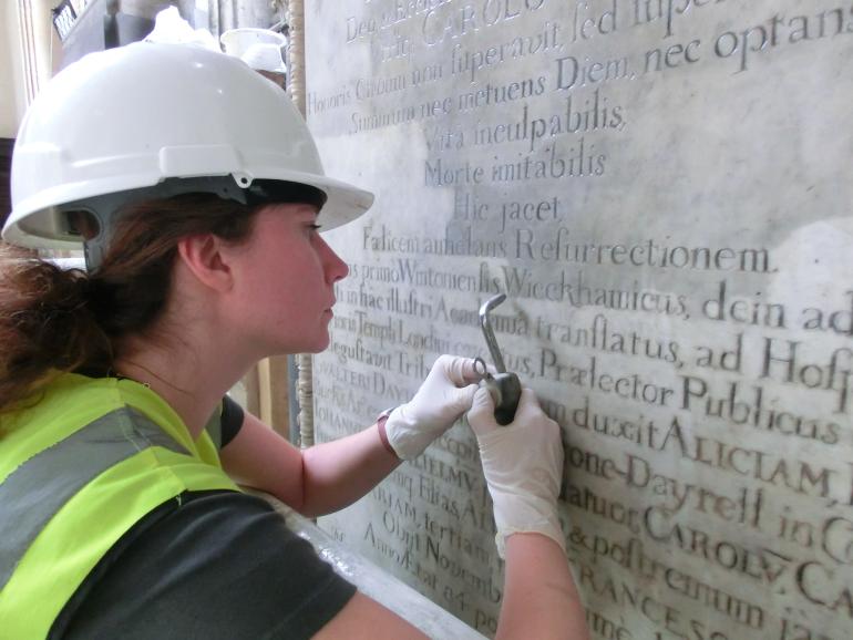 Cleaning letters on a memorial