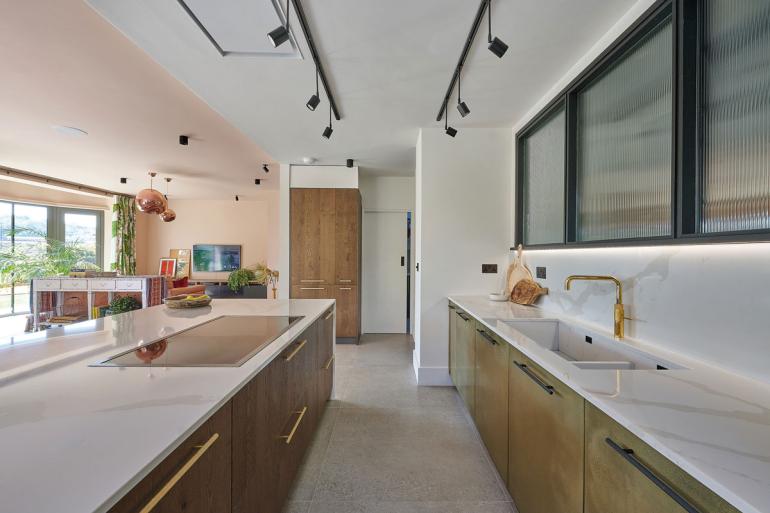 Every element of this kitchen is bespoke – from the sink to the brass cupboard doors with an aged patina effect