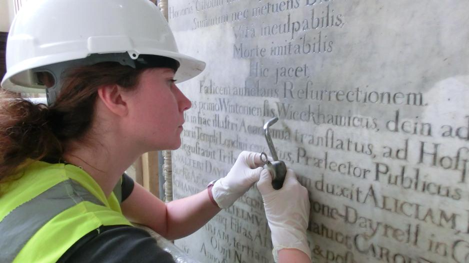 Cleaning letters on a memorial