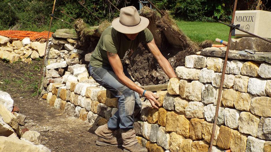 Emma Knowles building a dry stone wall