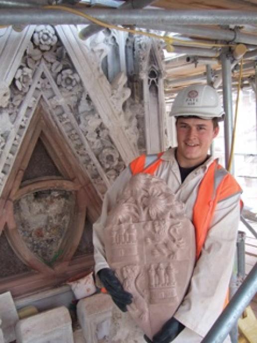 Rob Bessell holding a Red Mansfield shield on the back of which the masons have inscribed their initials. Rob Bessell holding a Red Mansfield shield on the back of which the masons have inscribed their initials.