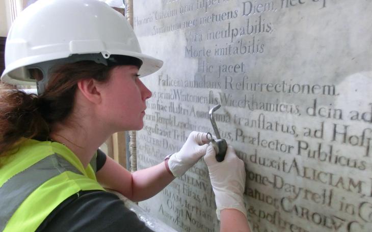 Cleaning letters on a memorial