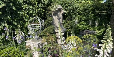 The Bridgerton Garden. Designed by Holly Johnston. Sponsored by Netflix. Sanctuary Garden. This garden featured a dry seam limestone moon gate and walls created by Natural by Design Dry Stone Walls and a bespoke wall fountain in Fletcher bank sandstone designed and carved by Ryan James. This garden was awarded Silver.